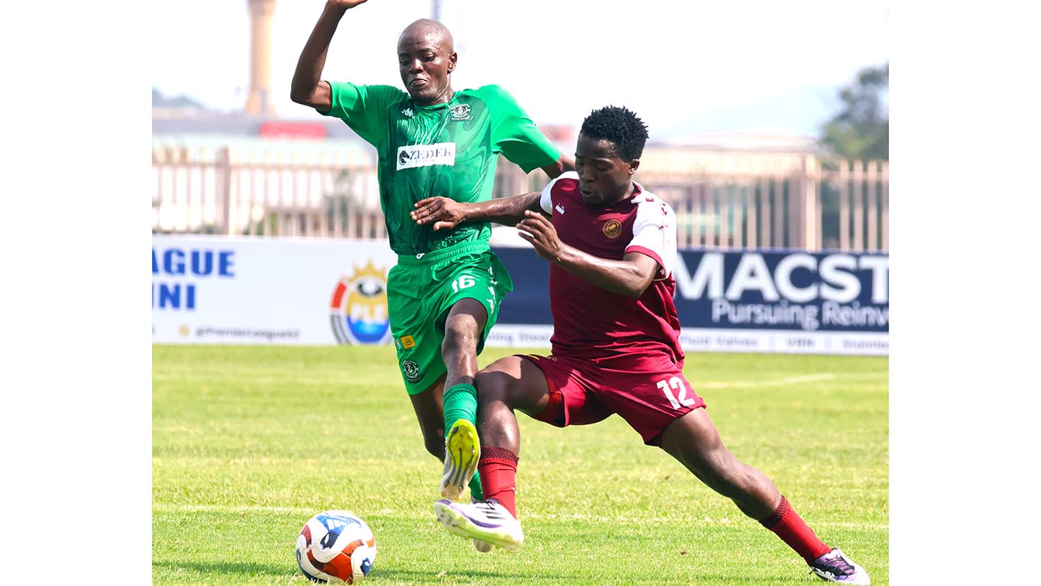 Manzini Wanderers' Mayibongwe Sacolo in tussle for the ball against Tabankulu Celtics' Vusi Mavuso. (Pic: Melusi Mkhabela)